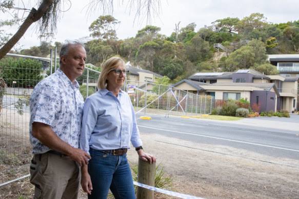 Couple standing near Australian suburban homes.