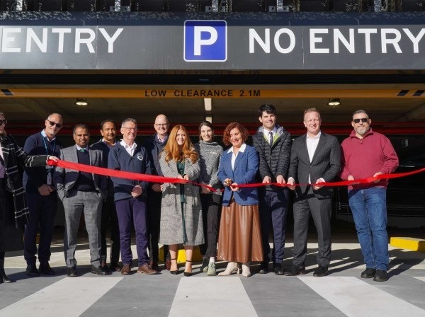 Group cutting ribbon at car park opening