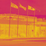 Infrared view of building with flags.