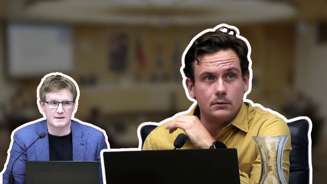 Two men at a conference with laptops.