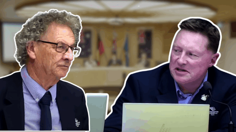 Two men discussing at a conference table.