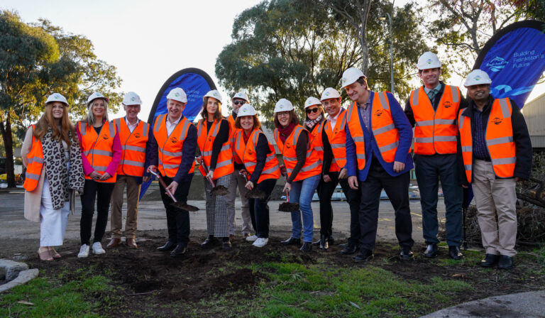 Group in safety gear at construction site groundbreaking
