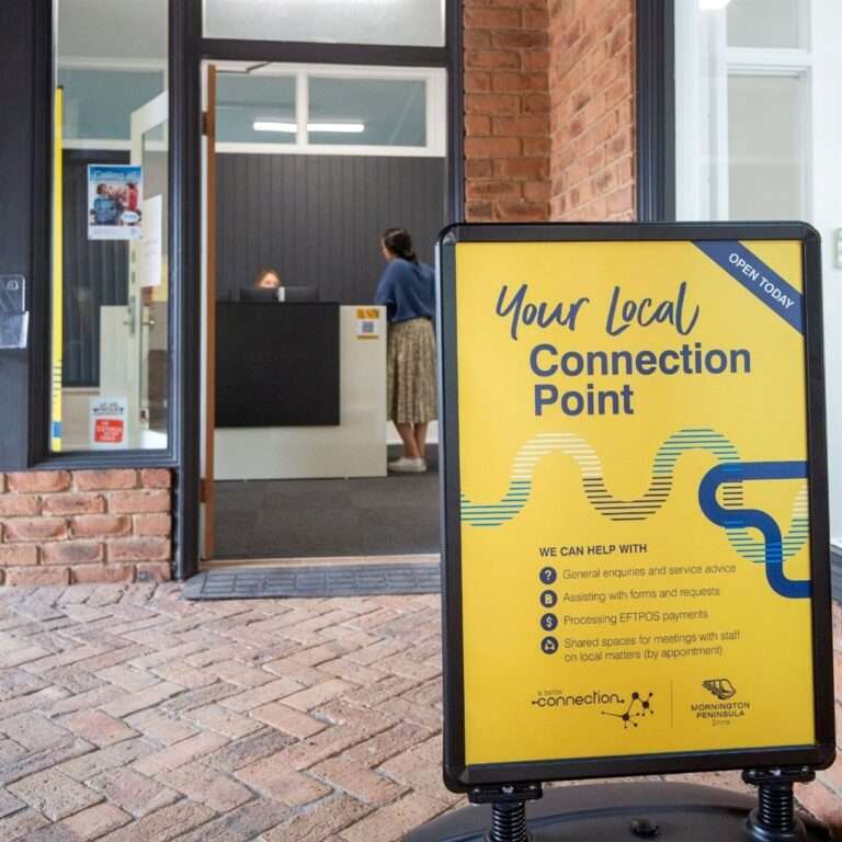 Local service centre entrance with informational sign.