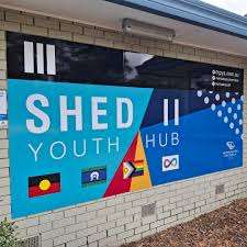 Shed II Youth Hub building sign with community flags