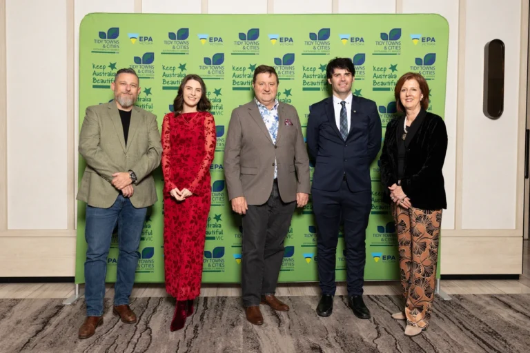 Five people posing at environmental event in Australia.