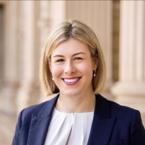 Professional woman smiling in formal suit.