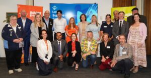 Group of people at community event with banners.