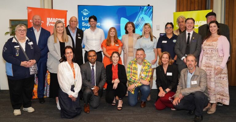 Group of people at community event with banners.