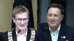 Two men speaking at a formal event.