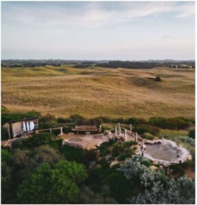 Scenic landscape with outdoor spa pools in nature.