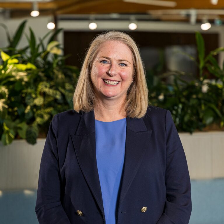 Smiling woman in office with plants background