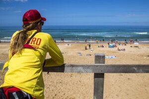 Surf lifesaver watching beach users
