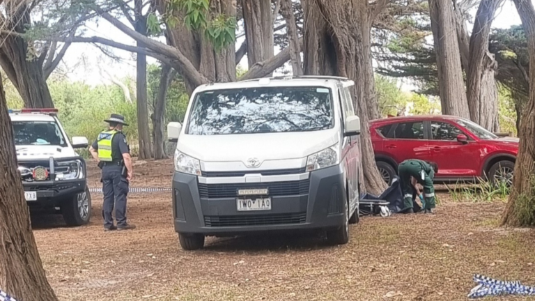 Police and coroner at crime scene.