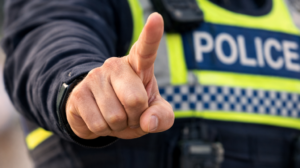 A police officer waiving their hand in disappointment.